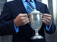 Businessman holding a trophy